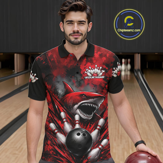 Man wearing a red and black graphic polo shirt with a shark design in a bowling alley.