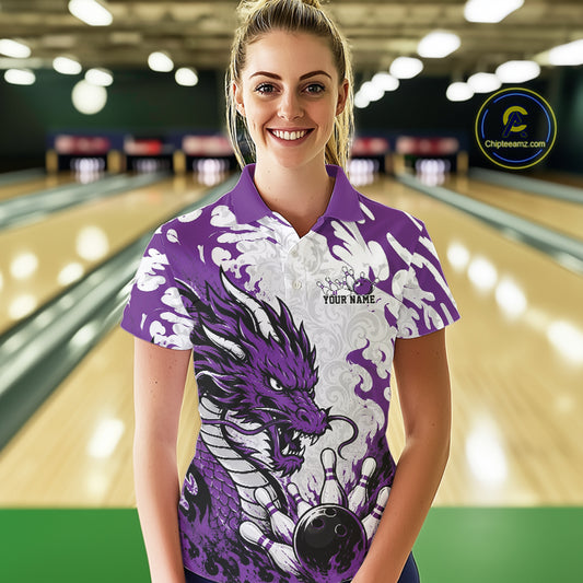 Woman wearing a purple and white bowling shirt with a dragon design in a bowling alley.
