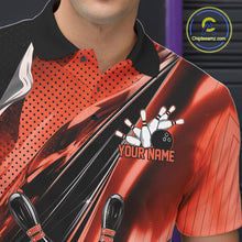 Load image into Gallery viewer, Close-up left chest detail of a black and orange bowling polo shirt featuring bowling strike artwork with speed streak accents.