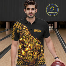 Load image into Gallery viewer, Male model wearing a black and gold bowling polo shirt at the lane with tribal-inspired bowling artwork.