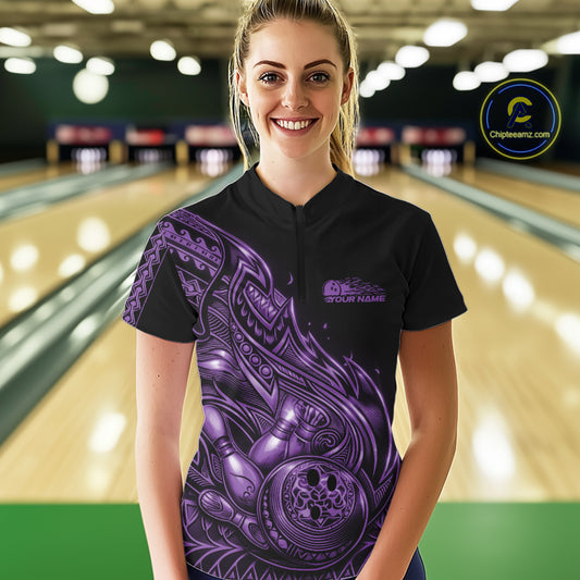 Female model wearing a black and purple bowling quarter-zip shirt at the bowling lane with tribal flame bowling accents.