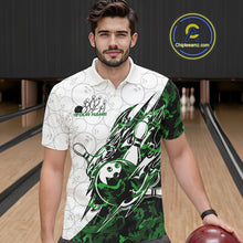 Load image into Gallery viewer, Male model wearing a white bowling polo shirt at the bowling lane with green camo bowling artwork and subtle ball patterns.