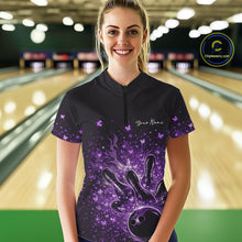 Load image into Gallery viewer, Female model in a black and purple bowling quarter-zip shirt at the lane with fiery bowling strike graphics.
