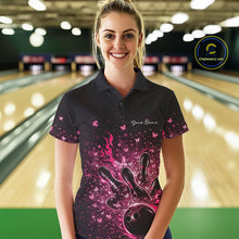 Load image into Gallery viewer, Female model wearing a black and pink bowling polo shirt at the lane with flaming bowling ball artwork.
