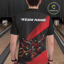 Load image into Gallery viewer, Male model seen from the back in a bowling lane wearing a black and red polo shirt featuring a flame bowling ball striking pins in a dynamic motion design.