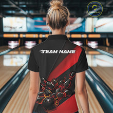 Load image into Gallery viewer, Female model back view at bowling center wearing black and red polo shirt showcasing flame bowling ball striking pins in bold dynamic artwork.