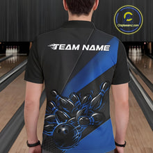 Load image into Gallery viewer, Male model seen from the back in a bowling lane wearing a black and blue polo shirt featuring a flame bowling ball striking pins in a dynamic motion scene.