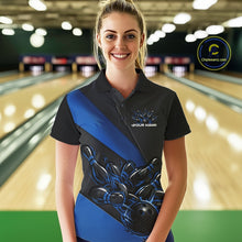 Load image into Gallery viewer, Female model front view in bowling venue wearing black and blue polo shirt with flaming bowling ball knocking down pins in energetic action scene.