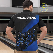 Load image into Gallery viewer, Bowling lane scene with a male model wearing a black and blue quarter zip shirt, highlighted by a fiery bowling ball striking pins in a bold athletic design.