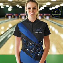Load image into Gallery viewer, Female model front view in bowling center wearing black and blue quarter zip shirt with flame bowling strike themed artwork
