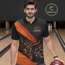 Load image into Gallery viewer, Male model seen from the front in a bowling lane wearing a black and orange polo shirt featuring a flame bowling ball striking pins in a dynamic action scene.