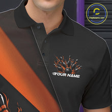 Load image into Gallery viewer, Close-up view of the left chest area of a black and orange bowling polo shirt showing a flame bowling ball and pins design detail.