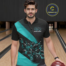 Load image into Gallery viewer, Male model seen from the front in a bowling lane wearing a black and turquoise blue polo shirt featuring a flame bowling ball striking pins in a dynamic sports scene.
