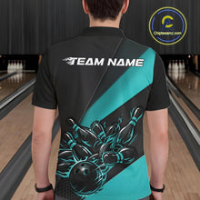 Load image into Gallery viewer, Male model seen from the back in a bowling lane wearing a black and turquoise blue polo shirt featuring a flame bowling ball striking pins in an energetic motion design.