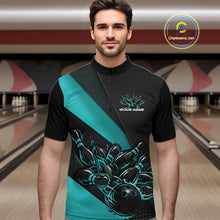 Load image into Gallery viewer, Male model seen from the front in a bowling lane wearing a black and turquoise quarter zip shirt featuring a flaming bowling ball striking pins in a dynamic action scene.