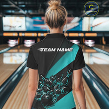 Load image into Gallery viewer, Back view female model in bowling alley wearing black and turquoise blue quarter zip shirt featuring flaming bowling action graphics