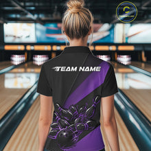 Load image into Gallery viewer, Female model back view in bowling center wearing black and purple polo shirt showcasing flame bowling ball striking pins in vivid motion artwork.