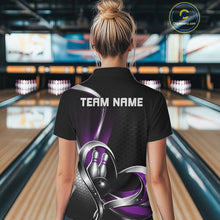 Load image into Gallery viewer, Back view of a female model in a bowling venue wearing a black and purple quarter zip shirt with honeycomb accents and a heart-shaped bowling ball and pins design.