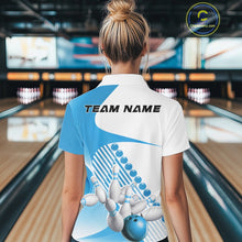Load image into Gallery viewer, Back view of a female model in a bowling lane wearing a white and light blue polo shirt, showcasing wavy asymmetric stripe accents and bowling action artwork.