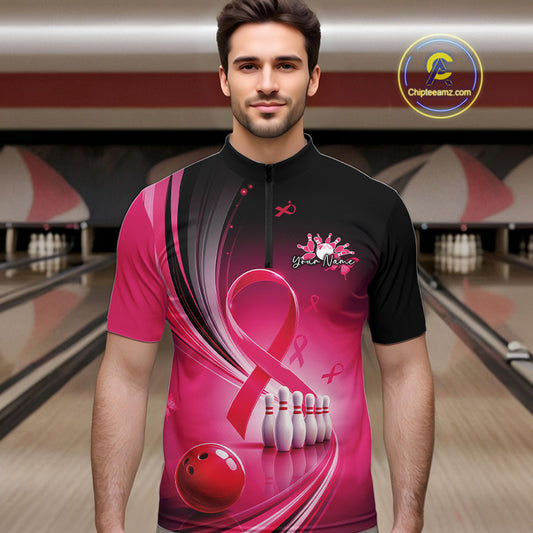 Male model wearing a black and pink bowling quarter zip with breast cancer awareness ribbon artwork and bowling graphics at the bowling lane