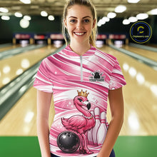 Load image into Gallery viewer, Female model at a bowling lane wearing a pink bowling quarter-zip shirt with a crowned flamingo, bowling ball, and bowling pin graphics.