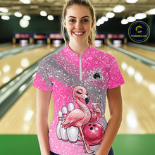 Load image into Gallery viewer, Female model at a bowling lane wearing a pink bowling quarter-zip shirt with an elegant flamingo, cocktail, and bowling ball artwork.