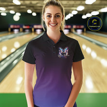 Load image into Gallery viewer, Female model wearing a colorful bowling polo shirt at a bowling lane with glowing butterfly artwork, a bowling ball, and fallen bowling pins.