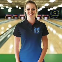 Load image into Gallery viewer, Female model at a bowling lane wearing a blue bowling polo shirt with glowing butterflies, a bowling ball centerpiece, and fallen pin graphics.