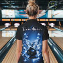 Load image into Gallery viewer, Back view of a female model in a bowling venue wearing a blue polo shirt showcasing luminous butterflies and cosmic bowling artwork.