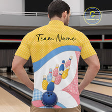 Load image into Gallery viewer, Front view of a male model in a bowling alley wearing a bowling quarter-zip shirt featuring colorful bowling-themed patchwork artwork.