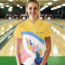 Load image into Gallery viewer, Female model at a bowling lane wearing a quarter-zip bowling shirt with vibrant patchwork bowling ball and pin artwork accented by polka dots.