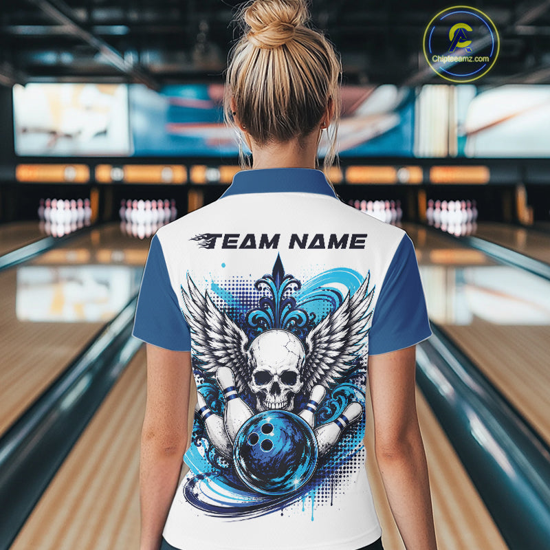 Back view of a woman in a bowling alley wearing a bowling shirt with quarter zip collar, blue skull-themed bowling graphic with black wings, pins, bowling ball shirt with “Team Name” across the shoulders.