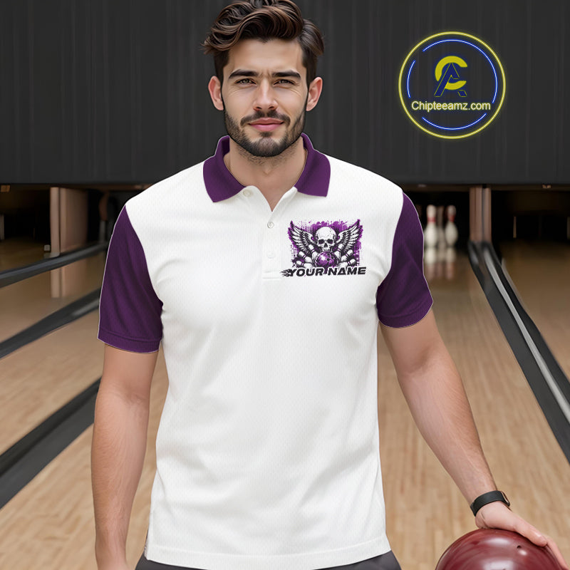 A man stands in a bowling alley wearing a bowling shirt with polo collar, purple skull-themed bowling graphic with black wings, pins, bowling ball