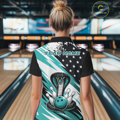 Back view of a woman in a bowling alley wearing a black, white, and blue american flag cobra-themed shirt with “Team Name” across the shoulders.