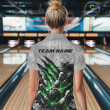 Load image into Gallery viewer, Back view of a female model wearing a gray bowling quarter zip shirt featuring a dramatic green bowling ball and pins graphic with claw-mark artwork in a bowling lane.