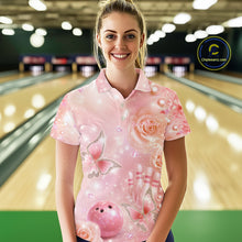 Load image into Gallery viewer, Female model at a bowling lane wearing a polo shirt with pink glitter butterflies, diamond details, bowling pins, and a bowling ball motif.