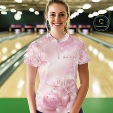 Load image into Gallery viewer, Front view of a female model wearing a bowling quarter-zip shirt at the lane with glitter butterfly motifs, diamonds, bowling pins, and a bowling ball.