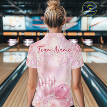 Load image into Gallery viewer, Back view of a female model at a bowling lane wearing a polo shirt featuring pink glitter butterflies, roses, bowling pins, and bowling ball artwork.