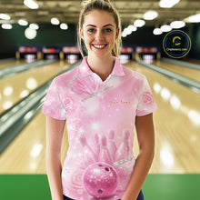 Load image into Gallery viewer, Female model at a bowling lane wearing a bowling polo shirt with pink glitter butterfly artwork, bowling pins, and a bowling ball on the front.