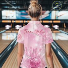 Load image into Gallery viewer, Back view of a female model in a bowling alley wearing a bowling polo shirt featuring pink glitter butterflies and bowling-themed graphics.