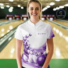Load image into Gallery viewer, Female model wearing a white and purple bowling quarter zip featuring butterfly artwork and bowling-themed graphics in a bowling venue.
