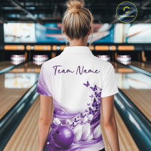 Load image into Gallery viewer, Back view of a white and purple bowling quarter zip with butterfly accents and bowling graphics inside a bowling center.