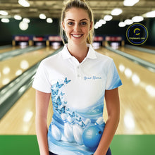Load image into Gallery viewer, Female model wearing a white and blue bowling polo shirt with butterfly artwork and bowling-themed graphics at the bowling lane.