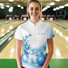 Load image into Gallery viewer, Front view of a female model in a white and blue bowling quarter zip with butterfly accents and bowling graphics inside a bowling alley.