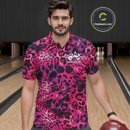 A man stands in a bowling alley wearing a yellow, brown, and black leopard-print bowling shirt with a bowling pin graphic and “Your Name” on the chest.