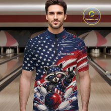 Load image into Gallery viewer, Front view of a male model at a bowling lane wearing a bowling quarter-zip shirt with a patriotic raccoon flashing a peace sign as a red, white, and blue bowling ball crashes through falling pins beneath a flowing American flag.