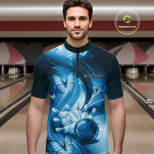 Load image into Gallery viewer, Male model in a bowling alley wearing a blue quarter-zip shirt with bowling ball and butterfly-themed artwork.