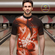 Load image into Gallery viewer, Male model at the bowling lane wearing an orange quarter-zip bowling shirt with bowling strike artwork and butterflies.