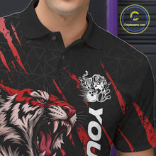 Load image into Gallery viewer, Close-up view of the left chest on a black and red bowling polo shirt displaying a roaring tiger holding a red bowling ball with matching red claw-stripe artwork and a geometric background pattern.