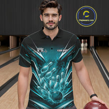 Load image into Gallery viewer, Male model at a bowling lane wearing a black and turquoise blue polo featuring explosive fire burst bowling graphics.